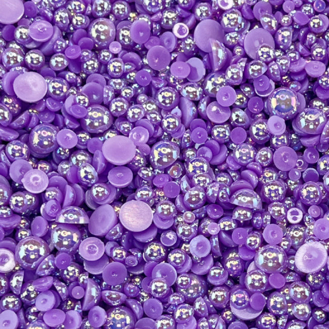 A close-up view of eggplant purple acrylic flat-back baubles embellishment mix.