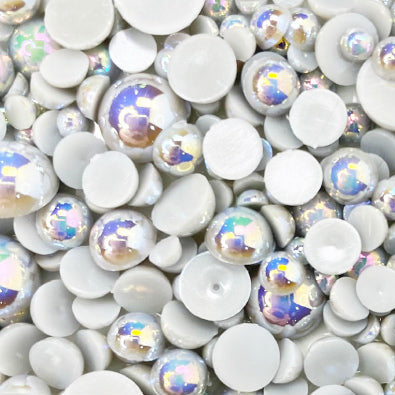 A variety of gray resin flat-back beads in an assortment of sizes, displayed on a surface.